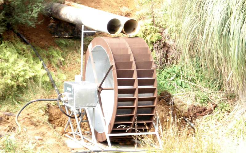 Yardmaster waterwheel with water diverted from existing lake running pump to storage tank