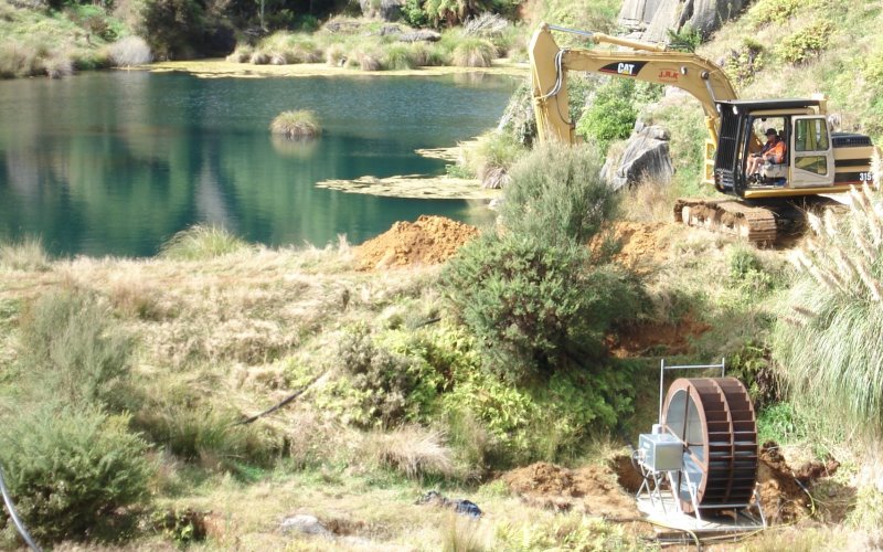 Yardmaster waterwheel with water diverted from existing lake running pump to storage tank