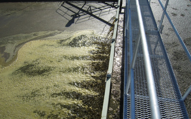 Plastic weeping wall between sand trap and storage tank