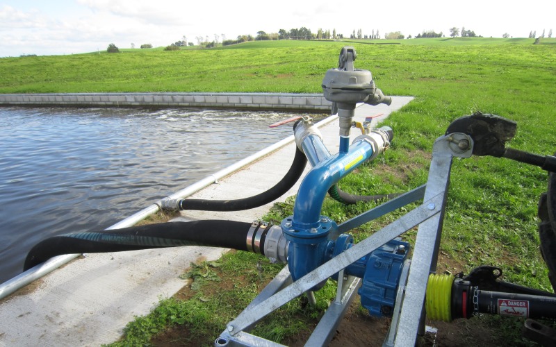 Yardmaster PTO pump with optional dual outlet manifold beside a large concrete sump